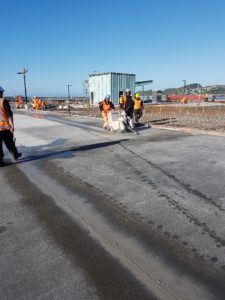 Workers prepare a concrete slab
