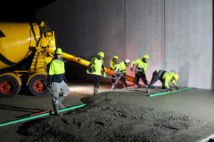 During the night, concrete placers pour prepared concrete with fibre reinforcing